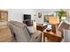 Bright living room with hardwood floors, modern furniture, and sliding door access to the outdoor area at 3331 Overland Ter, The Villages, FL 32163
