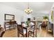 Open-concept dining area and living room with wood floors and natural light at 3331 Overland Ter, The Villages, FL 32163