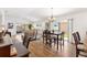 Comfortable living area with wood floors, dining table and sliding glass doors leading to patio at 3331 Overland Ter, The Villages, FL 32163