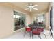 Enclosed patio offering an outdoor dining area and sliding door access to the home at 3331 Overland Ter, The Villages, FL 32163