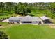 Aerial view showcasing the property's spacious yard, including a screen porch and covered parking area at 38314 Echols Rd, Leesburg, FL 34788