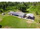 Aerial view showcasing the property's spacious yard, including a screen porch and covered parking area at 38314 Echols Rd, Leesburg, FL 34788
