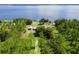 Beautiful aerial view of the home with access to Lake Yale and featuring mature trees and a dock at 38314 Echols Rd, Leesburg, FL 34788