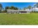 Lush, expansive backyard featuring a screened-in porch, mature trees, and ample space for outdoor activities at 38314 Echols Rd, Leesburg, FL 34788