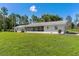 Expansive backyard with lush green grass and a screened-in porch at 38314 Echols Rd, Leesburg, FL 34788