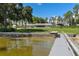 Sprawling backyard with waterfront views, a private dock, and lush green lawn at 38314 Echols Rd, Leesburg, FL 34788
