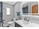 Elegant bathroom featuring modern fixtures, an illuminated mirror, and blue tiled shower at 38314 Echols Rd, Leesburg, FL 34788