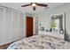 Serene bedroom features white closet doors, a ceiling fan, and calming coastal decorations at 38314 Echols Rd, Leesburg, FL 34788