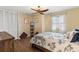 Comfortable bedroom with a ceiling fan, wood flooring, closet, and window with natural light at 38314 Echols Rd, Leesburg, FL 34788