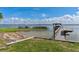 Waterfront property featuring a private dock with a boat house on a serene lake at 38314 Echols Rd, Leesburg, FL 34788