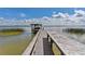 Private wooden dock extends into the calm lake, ideal for boating and fishing at 38314 Echols Rd, Leesburg, FL 34788