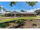 Charming brick home with manicured lawn and garden beds underneath large shade trees at 38314 Echols Rd, Leesburg, FL 34788