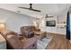 Living room with comfortable seating, built-in shelves and wood-look floors at 38314 Echols Rd, Leesburg, FL 34788