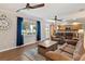 Cozy living room features comfortable leather seating, ceiling fans, and lake view at 38314 Echols Rd, Leesburg, FL 34788