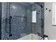 Modern shower featuring blue subway tiles and black fixtures, creating a sleek and stylish space at 38314 Echols Rd, Leesburg, FL 34788