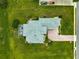 Bird's-eye view of a well-kept home with screened lanai, brick driveway, and lush yard in a tranquil neighborhood at 39145 Treeline Dr, Lady Lake, FL 32159