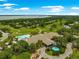 Breathtaking aerial view of the community clubhouse, pool, golf course and surrounding nature at 39145 Treeline Dr, Lady Lake, FL 32159