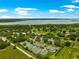 Beautiful community aerial view featuring tennis courts, a lake and verdant green landscape at 39145 Treeline Dr, Lady Lake, FL 32159