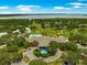 Stunning aerial view of the clubhouse, golf course, and waterfront of this community at 39145 Treeline Dr, Lady Lake, FL 32159
