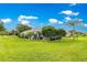 Well-maintained backyard showing ample green space and mature landscaping surrounding the home's exterior at 39145 Treeline Dr, Lady Lake, FL 32159