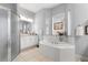 Bright bathroom featuring a large soaking tub surrounded by windows and a glass shower at 39145 Treeline Dr, Lady Lake, FL 32159