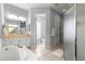 Bathroom featuring a large soaking tub, glass shower, dual sinks, and tile floors at 39145 Treeline Dr, Lady Lake, FL 32159
