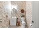 Charming half-bathroom features decorative wallpaper, white vanity, and matching oval mirror at 39145 Treeline Dr, Lady Lake, FL 32159