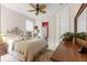 Cozy bedroom features neutral walls, plush carpet, with a view of the bathroom at 39145 Treeline Dr, Lady Lake, FL 32159