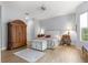 Spacious bedroom showcasing wood-look tile floors, ceiling fan, and ample natural light at 39145 Treeline Dr, Lady Lake, FL 32159