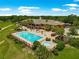 Community outdoor pool with lounge chairs, well-manicured landscaping, and relaxing lounge areas at 39145 Treeline Dr, Lady Lake, FL 32159