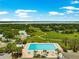 Community pool with beautiful landscaping, lounge chairs, and stunning water views at 39145 Treeline Dr, Lady Lake, FL 32159