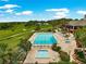 Community pool with plenty of lounge chairs, mature landscaping, and nearby golf course at 39145 Treeline Dr, Lady Lake, FL 32159
