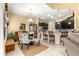 Charming dining area next to kitchen with stylish chairs and a chandelier at 39145 Treeline Dr, Lady Lake, FL 32159
