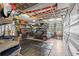 Organized garage with a parked Smart car, extensive tool storage, and overhead shelving at 39145 Treeline Dr, Lady Lake, FL 32159