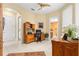 Bright home office features a desk and custom wood cabinet, as well as natural lighting and tile flooring at 39145 Treeline Dr, Lady Lake, FL 32159