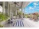Screened lanai with ceiling fan, white wicker furniture, view of backyard and pool at 39145 Treeline Dr, Lady Lake, FL 32159