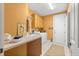 Bright laundry room featuring yellow walls, cabinets, a wash sink, washer and dryer units at 39145 Treeline Dr, Lady Lake, FL 32159