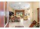 Bright living room featuring tile flooring, a ceiling fan, and expansive views through large windows at 39145 Treeline Dr, Lady Lake, FL 32159