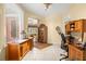 Bright office featuring wood cabinetry, tile floors, and arched doorways at 39145 Treeline Dr, Lady Lake, FL 32159