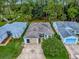 An aerial view of a single-story home with a manicured lawn and inviting curb appeal at 409 Westwood Dr, Leesburg, FL 34748
