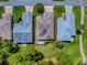 Overhead view of a house highlighting the roof and surrounding property lines and adjacent neighborhood homes at 409 Westwood Dr, Leesburg, FL 34748