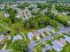 Aerial view of a residential area with houses, green spaces, and golf course at 409 Westwood Dr, Leesburg, FL 34748