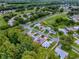 A neighborhood from above with well-maintained homes, golf course, and green surroundings at 409 Westwood Dr, Leesburg, FL 34748