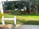 Serene backyard view with lush greenery and mature trees providing ample shade at 409 Westwood Dr, Leesburg, FL 34748