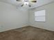 This bedroom features carpet floors, a ceiling fan, and a window at 409 Westwood Dr, Leesburg, FL 34748