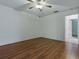 This bedroom features wood floors and an ensuite bathroom at 409 Westwood Dr, Leesburg, FL 34748