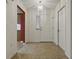 Inviting foyer with neutral tile flooring, closet and decorative light fixture at 409 Westwood Dr, Leesburg, FL 34748