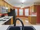 Kitchen with stainless steel appliances and breakfast nook that is bathed in natural light at 409 Westwood Dr, Leesburg, FL 34748