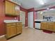 Kitchen with wooden cabinetry, tile backsplash and an open view of the breakfast area at 409 Westwood Dr, Leesburg, FL 34748