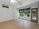 This is a sunroom with ceramic tile flooring and large windows at 409 Westwood Dr, Leesburg, FL 34748